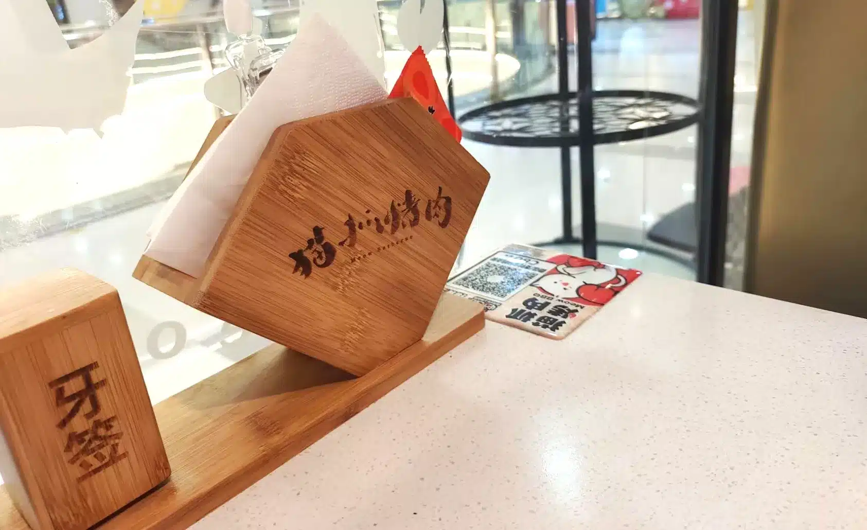 disposable paper napkin in napkin holder on restaurant table