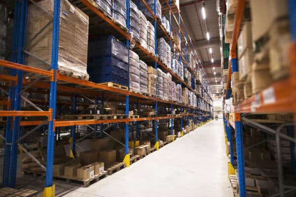 interior large distribution warehouse with shelves stacked with palettes goods ready market