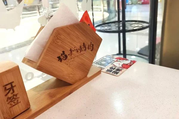 disposable paper napkin in napkin holder on restaurant table